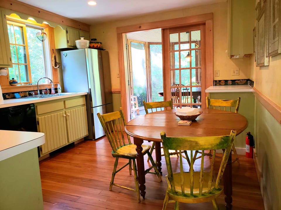 Eat-in kitchen with French doors leading you onto the  screened dining porch