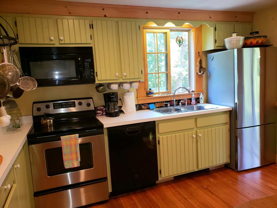 Eat-in kitchen with French doors leading you onto the  screened dining porch