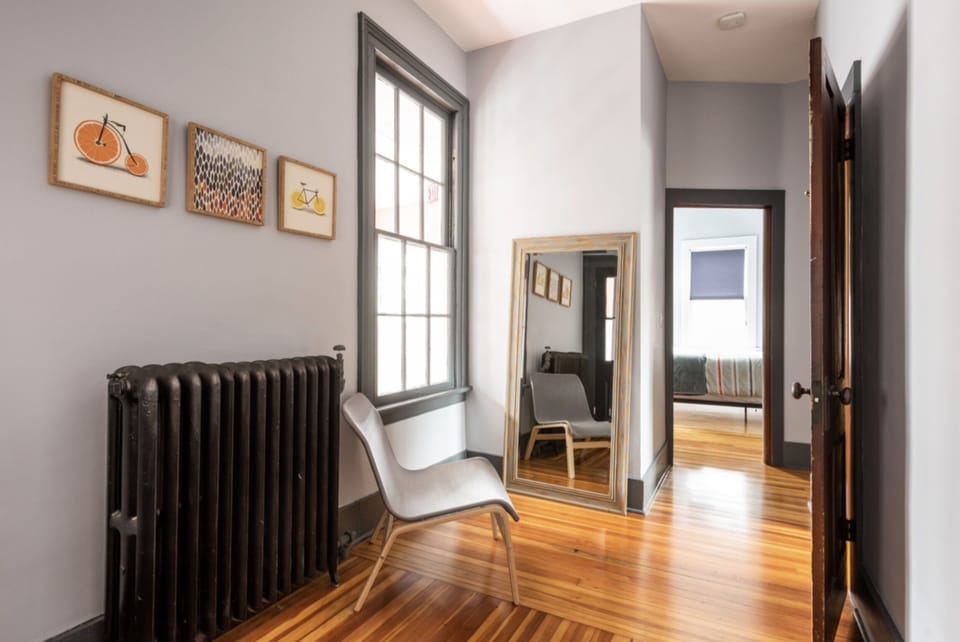 Hallway from kitchen to 3 bedrooms, with full-length mirror