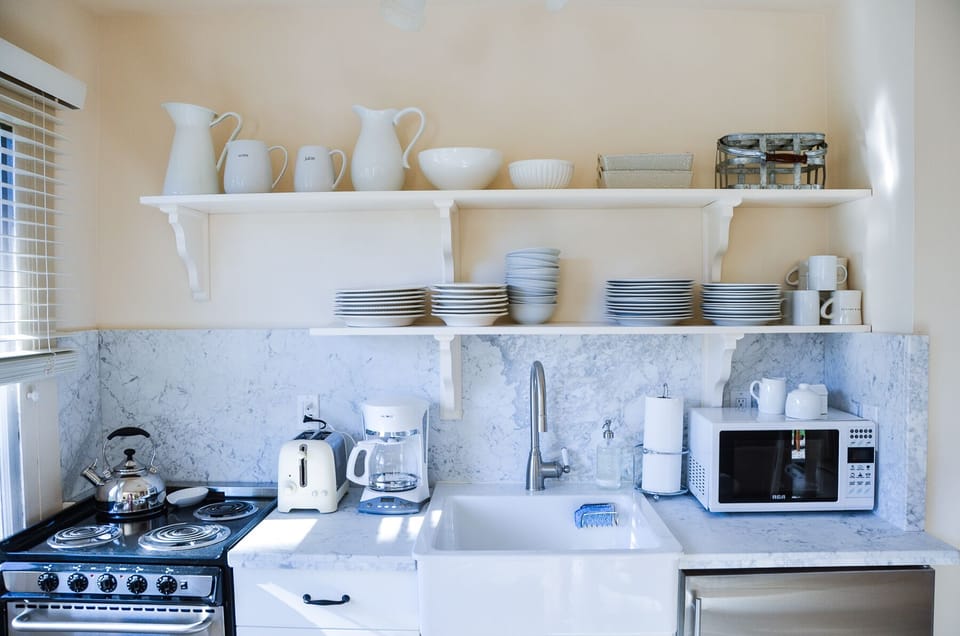 Convenient kitchen and BBQ outside.  Small but well-stocked! Photo by Carol Troy