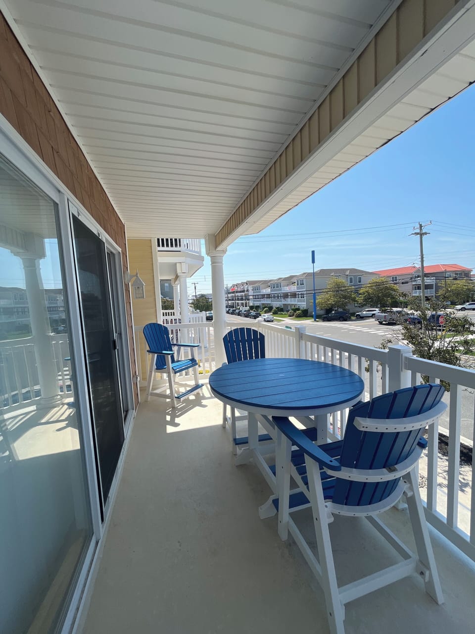 Covered porch with four chairs and table 