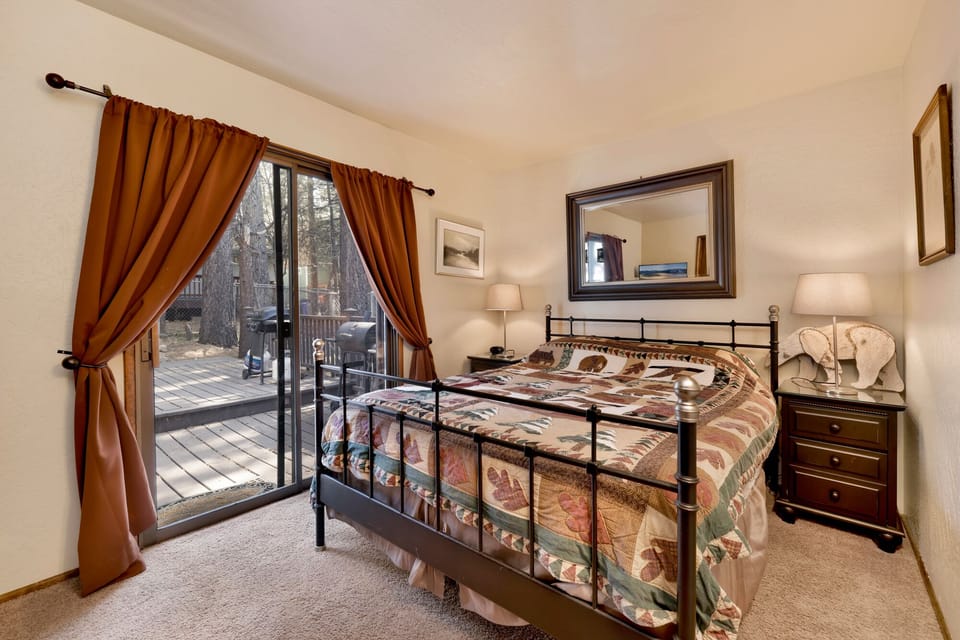 Peaceful cabin bedroom with plush bedding, and beautiful views—ideal for restful nights, cozy mornings, and a relaxing mountain escape.