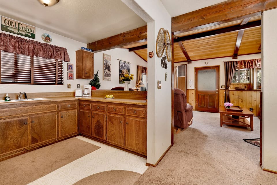 Fully equipped cabin kitchen with ample cabinetry, stove, fridge, microwave, and coffee maker—perfect for cooking meals, morning coffee, and feeling right at home on your stay.