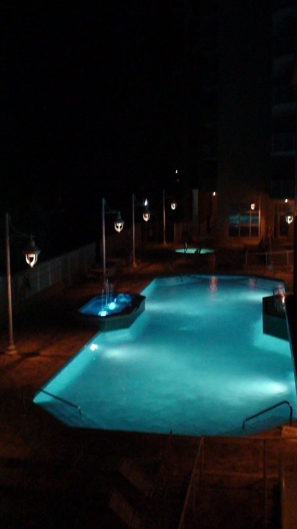 Pool & hot tub at night illuminated by LED lights. A perfect way to end the day!