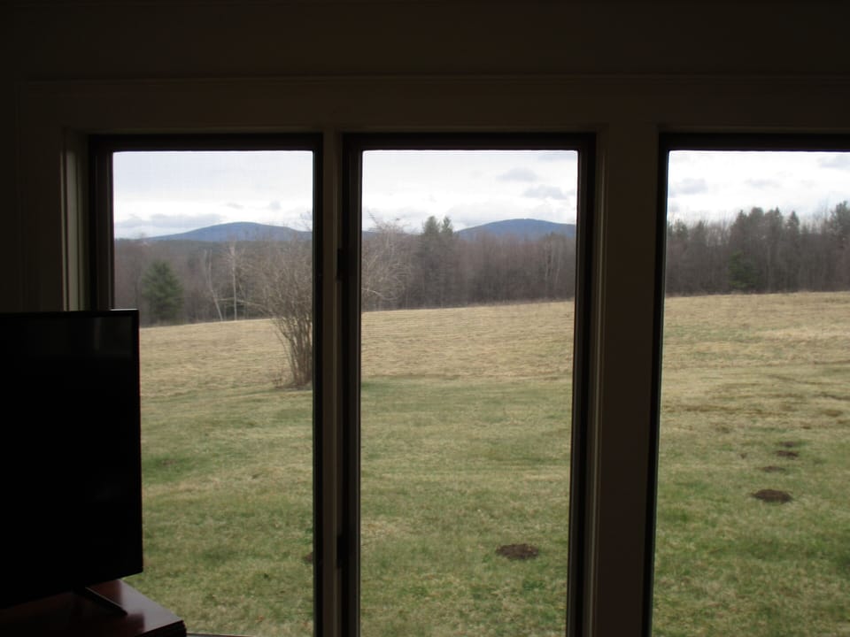 View of Pack Monadnock + property's 8 acres open field from wrap around sunroom