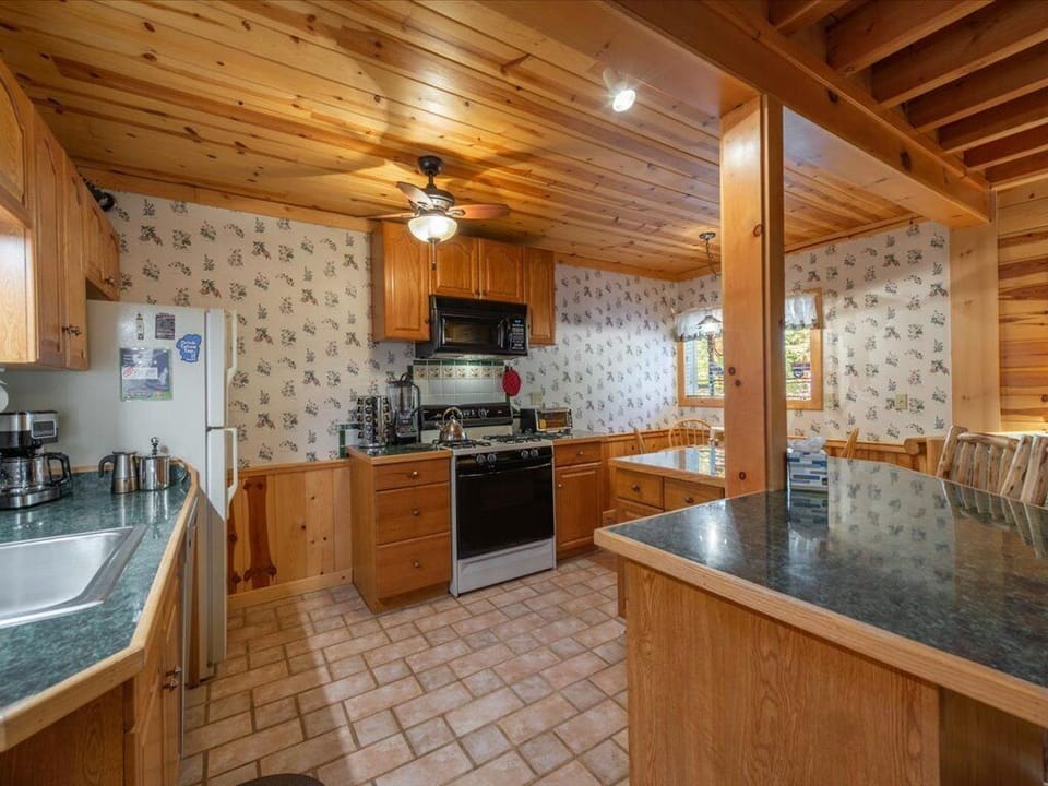 Open kitchen with plenty of counter space and breakfast bar for two