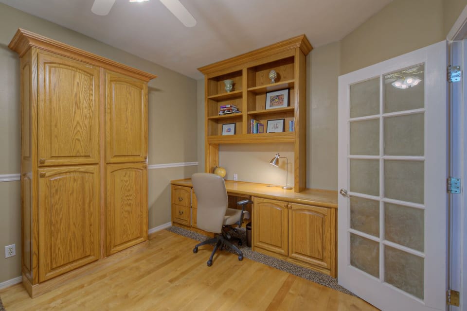 Bedroom 5 has a large desk with computer space and a rolling chair  for your remote work.