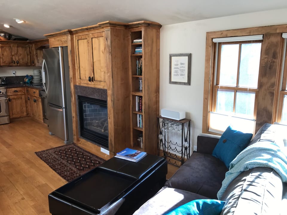 Looking back into kitchen - cupboard above fireplace hides TV/DVD, modem etc.