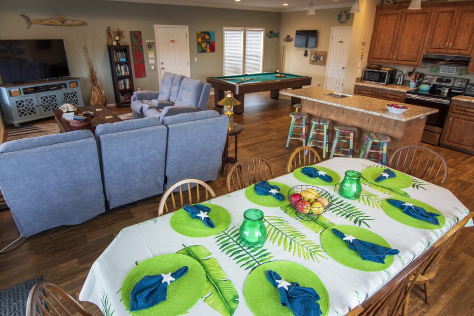 Dining table with seating for 8, open to den, kitchen and pool table area