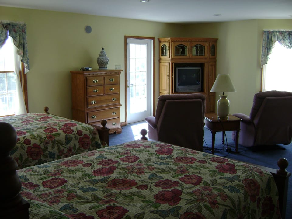 West Wing Suite - 2 Queen Beds! Door leads to a balcony.