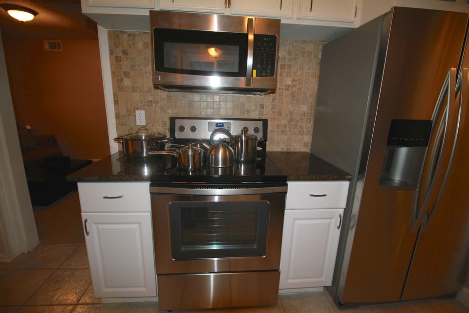 Lots of pots and pans, dishes, cups,
glasses available