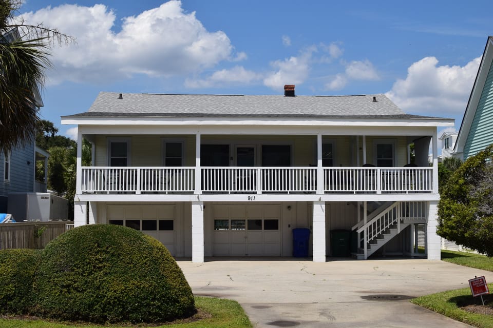 Front view of home with large driveway and plenty of parking 
