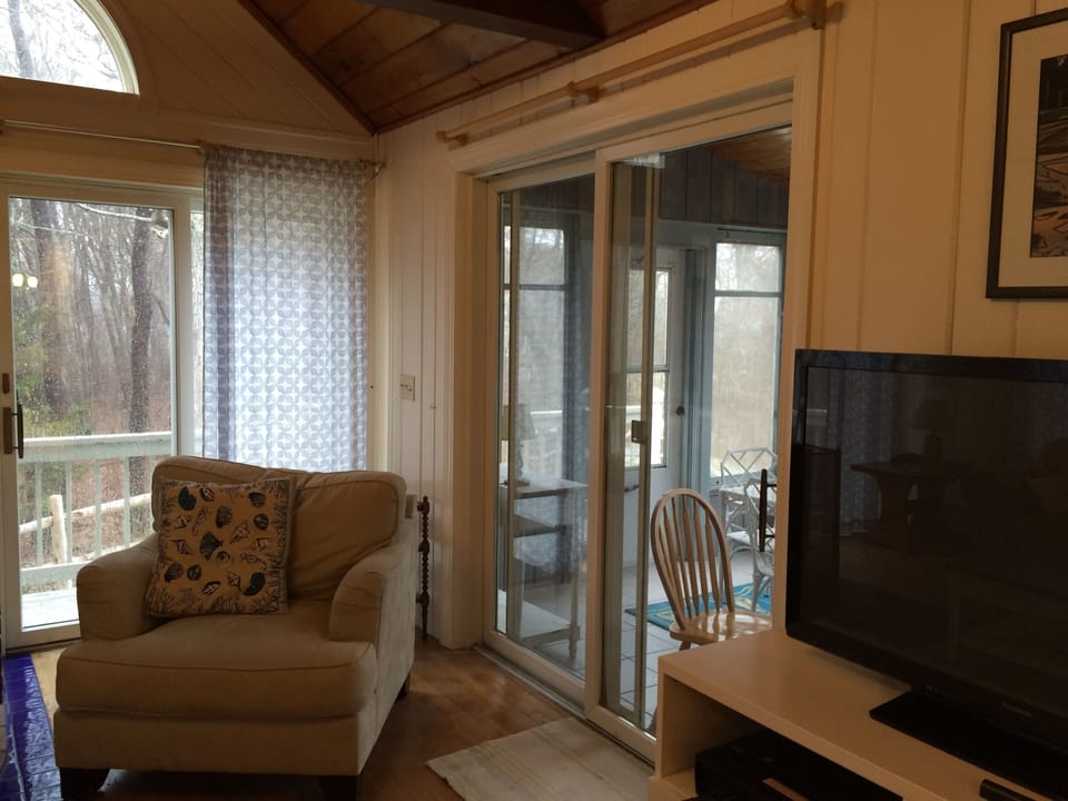 Family room has access to small screened porch and side deck.
