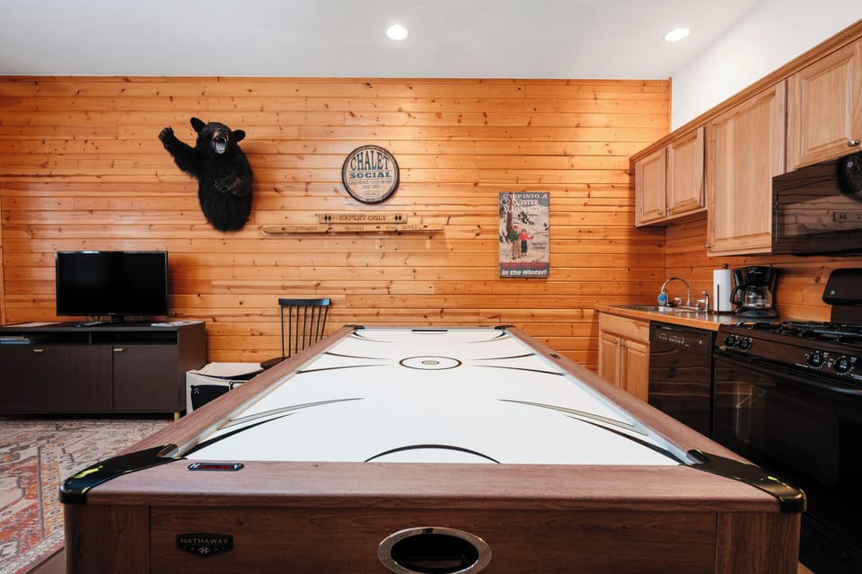 Lower level kitchen and  living room with board games and arcade table