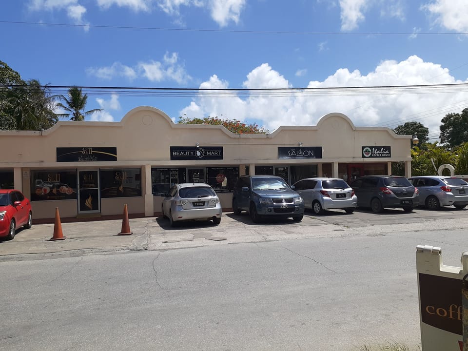 Mini mall across the street from condo with beauty salons and 8.11 Bistro