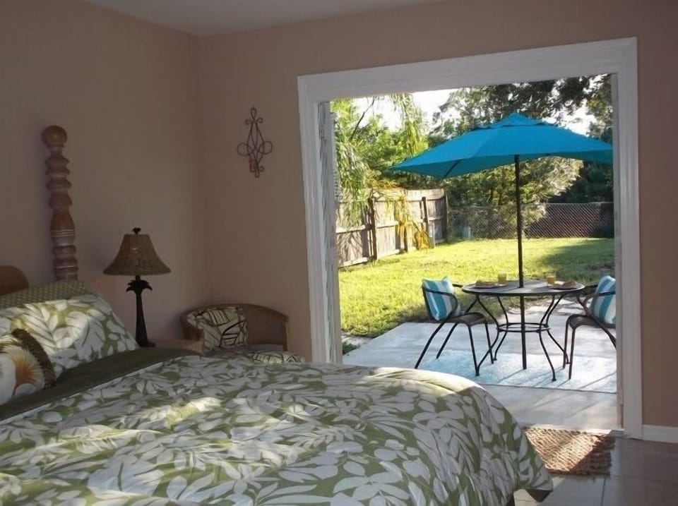 Master bedroom with French doors that lead out to a private outdoor area.