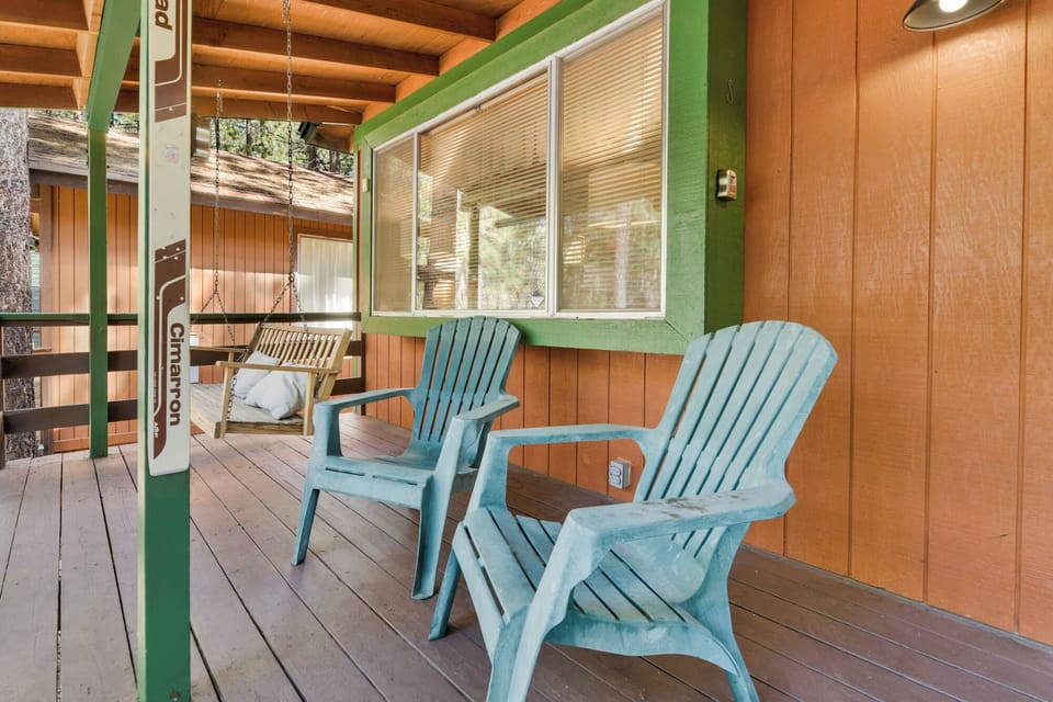 Welcoming cabin entry surrounded by towering pine trees, offering fresh mountain air and a peaceful forest setting—the perfect first impression for your Big Bear Lake getaway.