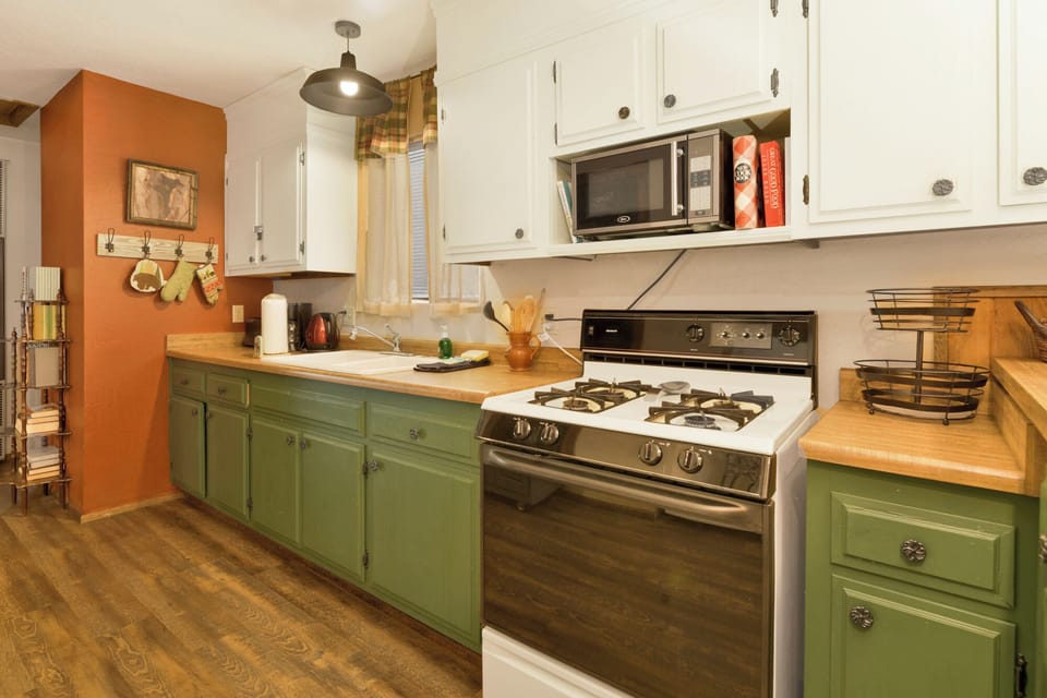 Fully equipped cabin kitchen with ample cabinetry, stove, fridge, microwave, and coffee maker—perfect for cooking meals, morning coffee, and feeling right at home on your stay.
