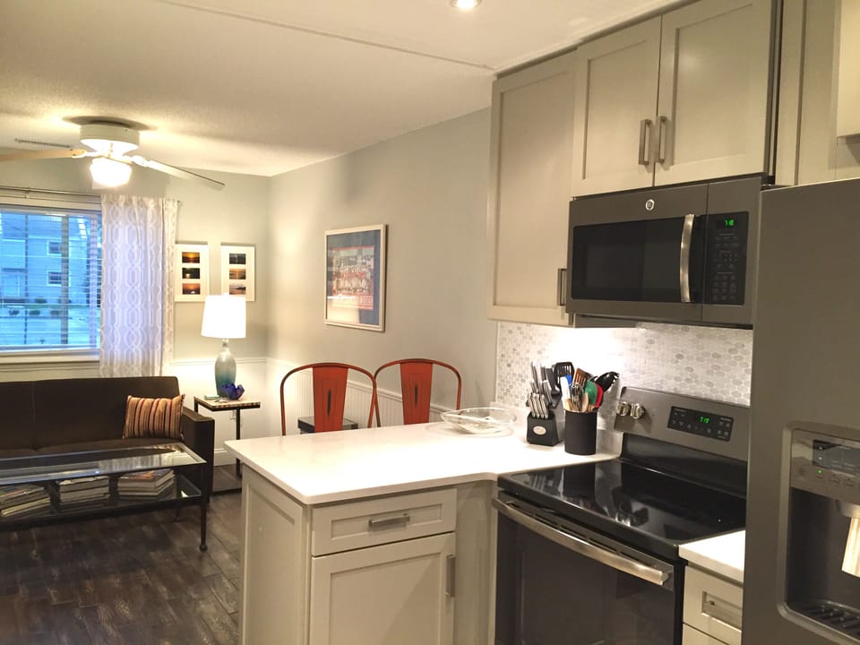 Renovated and fully stocked kitchen with custom back splash and breakfast bar.  