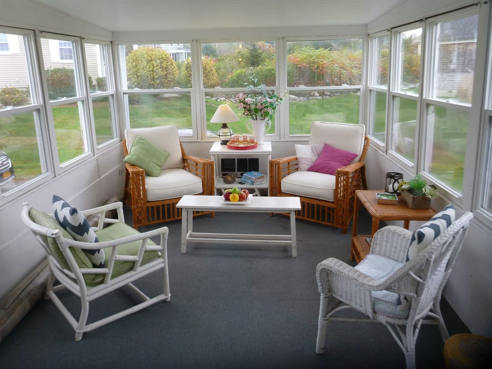 Screened porch offers ocean breezes, songbirds in the meadow, cocktails?