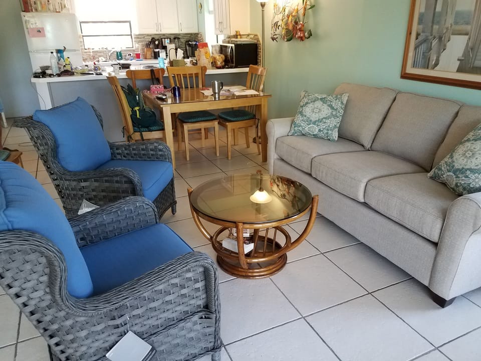 2nd floor living room with queen-sized pullout sofa bed; kitchen in background