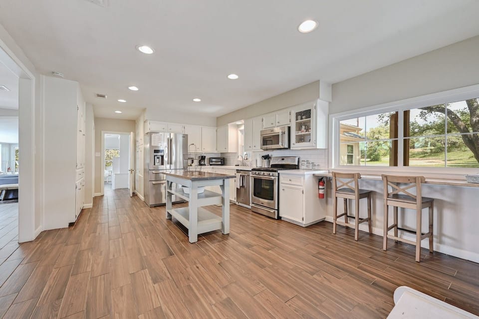 Wood breakfast counter with stools for morning coffee and casual meals.