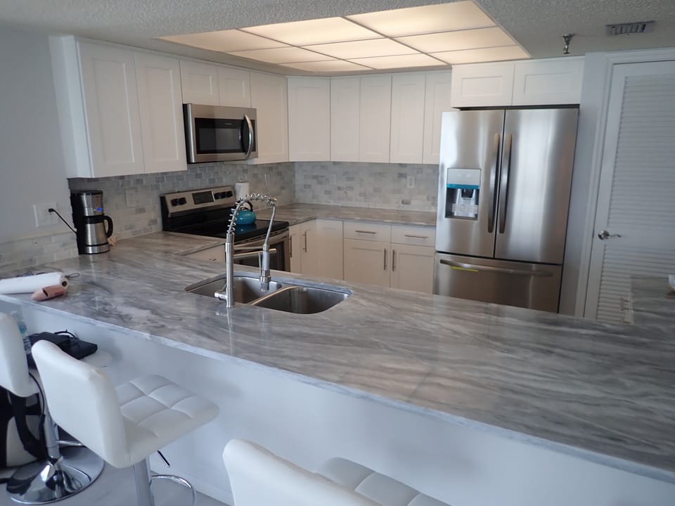 Granite countertops, marble backsplash, custom cabinets in brand new kitchen