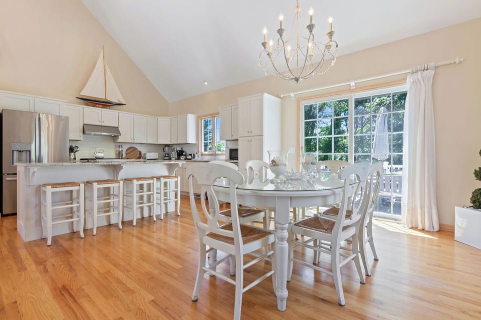 Spacious living area with cathedral ceilings and dining table.