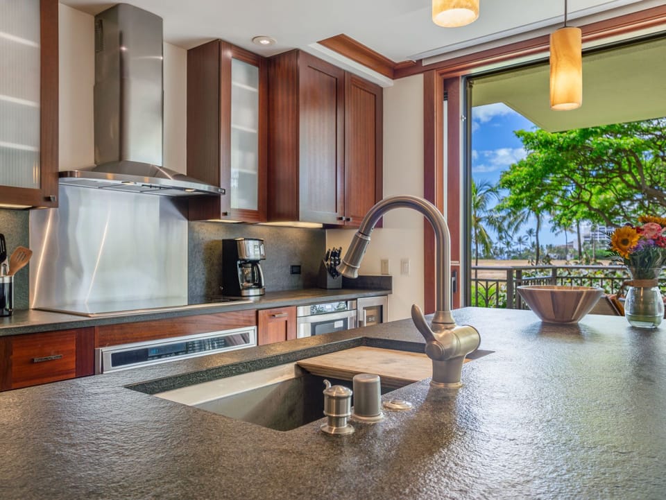 Roy Yamaguchi designer kitchen with black granite and mahagoney cabinets
