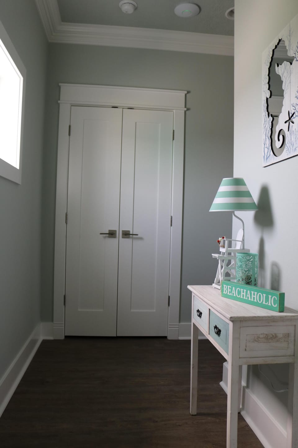 Landing at top of stairs with Laundry closet.