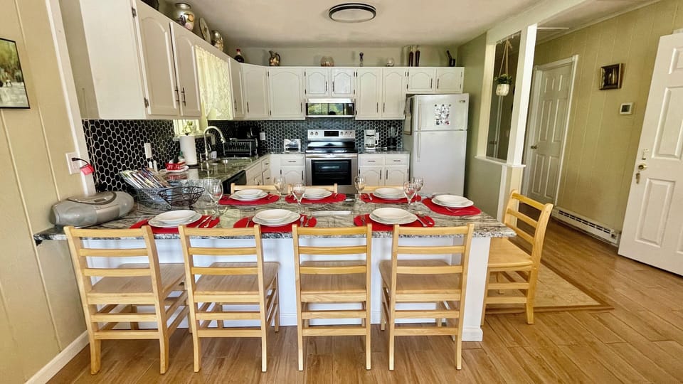 Spacious kitchen with a dining table.