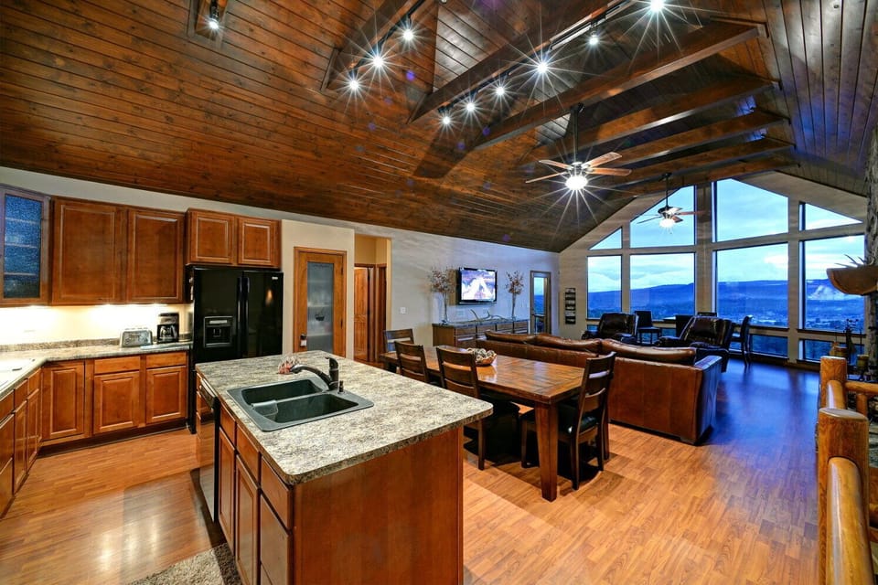 Kitchen, dining room and family room, flat panel TV, pub table.