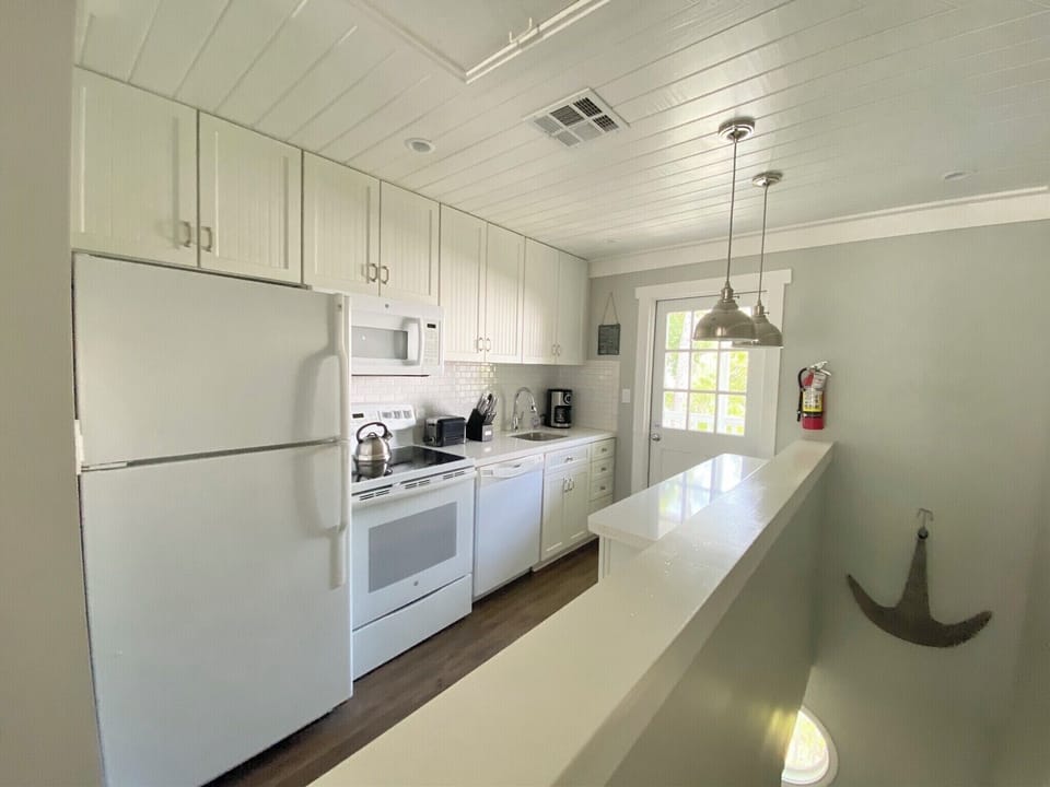 Well stocked kitchen with a covered porch for drinking your morning coffee.