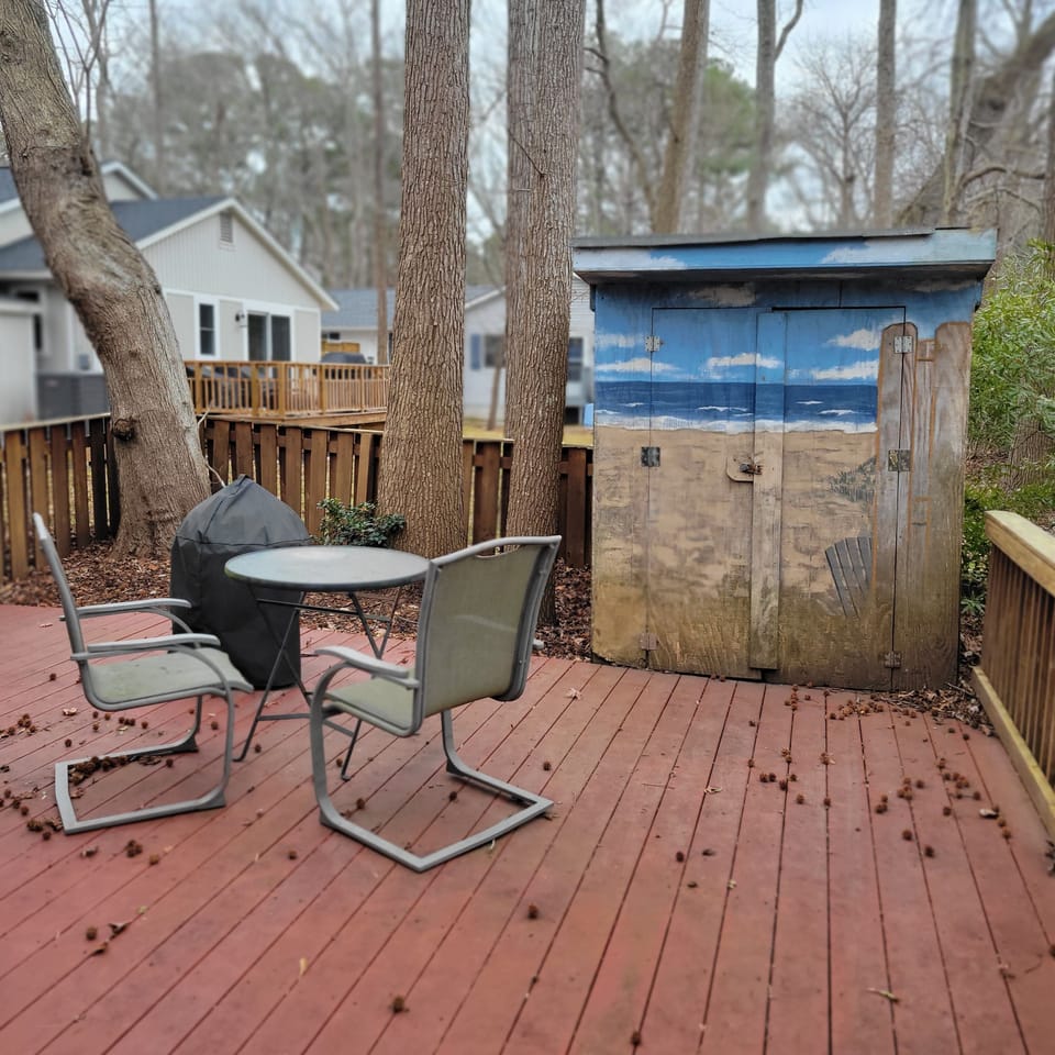 Back deck with storage for bikes, chairs and toys; charcoal grill,outside shower