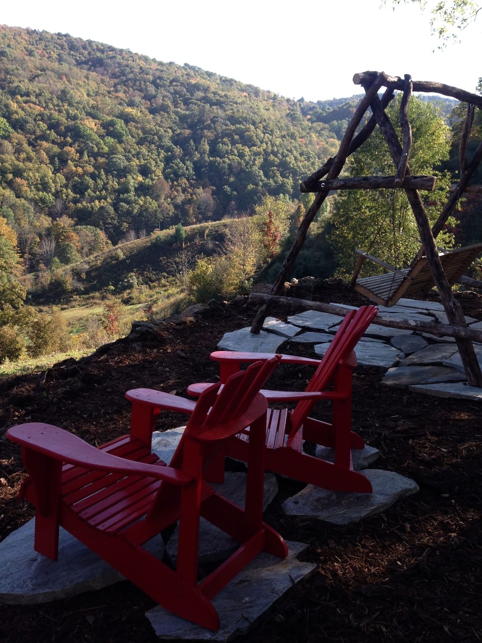 Adirondack chairs and A-frame swing at the end of the easy trail from the cabin