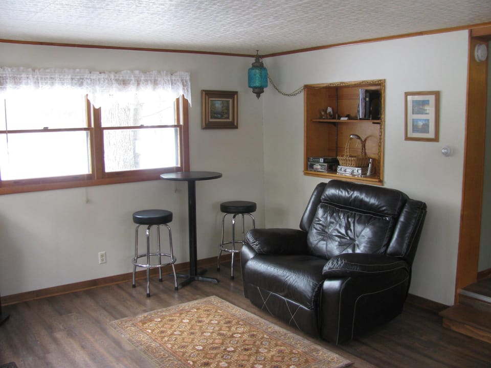 Comfy, oversized recliner and high top pub table.