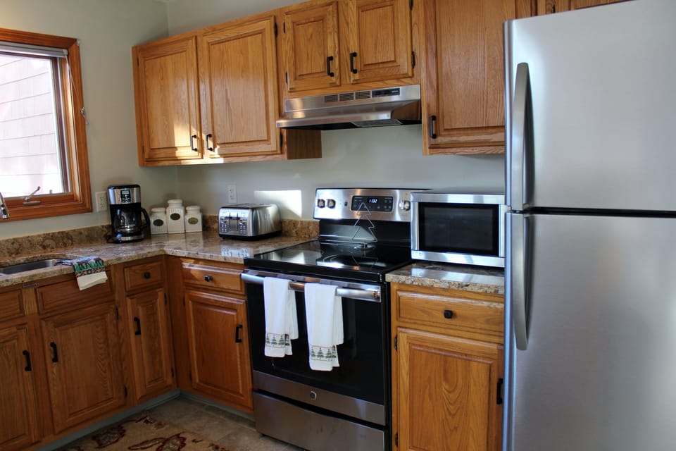 Fully stocked kitchen with stainless steel appliances. 