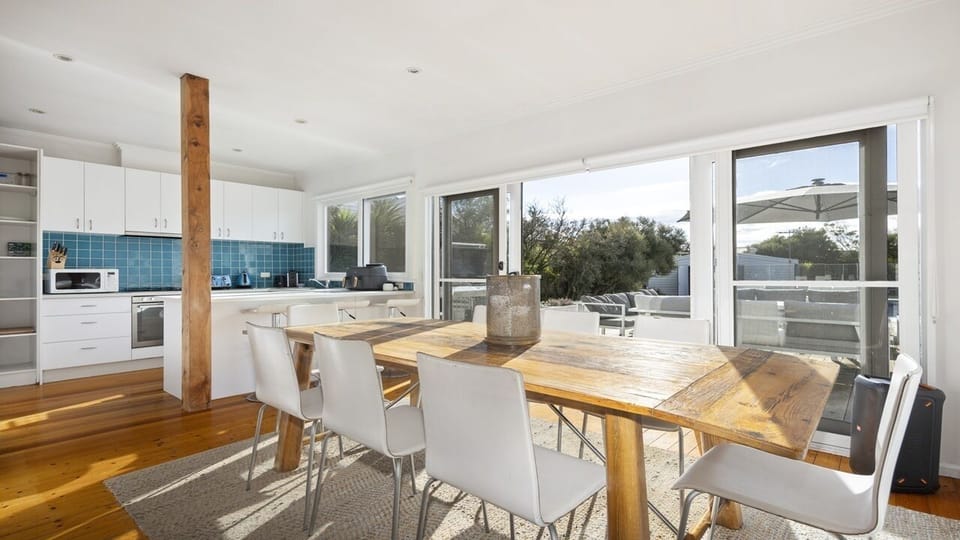 Kitchen and dining room with pool and garden view