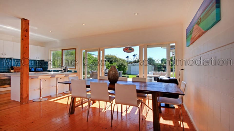 Open plan kitchen and meals area opening out to outdoor deck