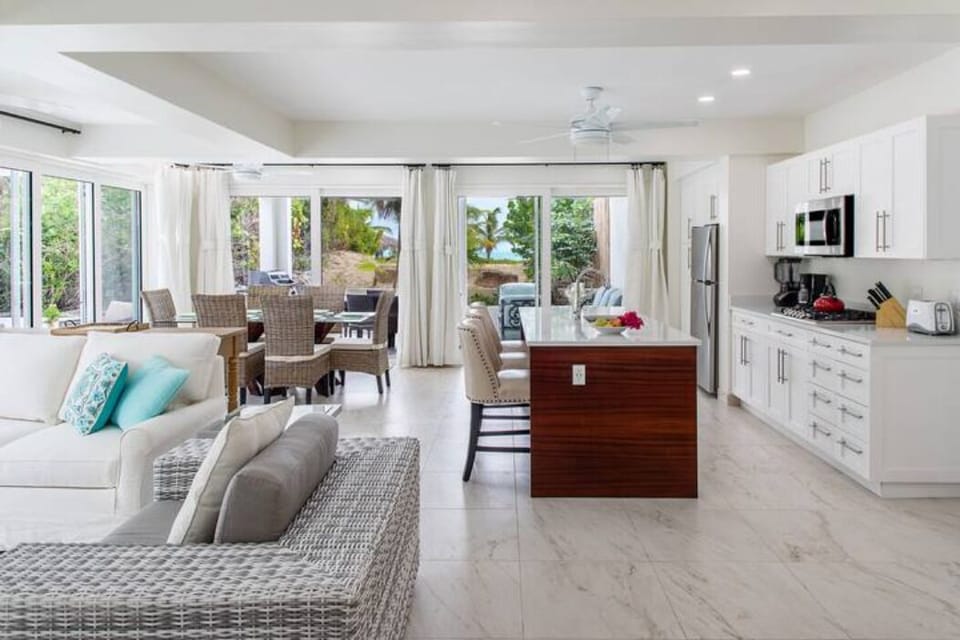 Experience the grandeur of the great room, where the living area boasts breathtaking views of both the beach and the garden. Enjoy the stunning vistas from the bedroom as well, adding to the allure of your surroundings