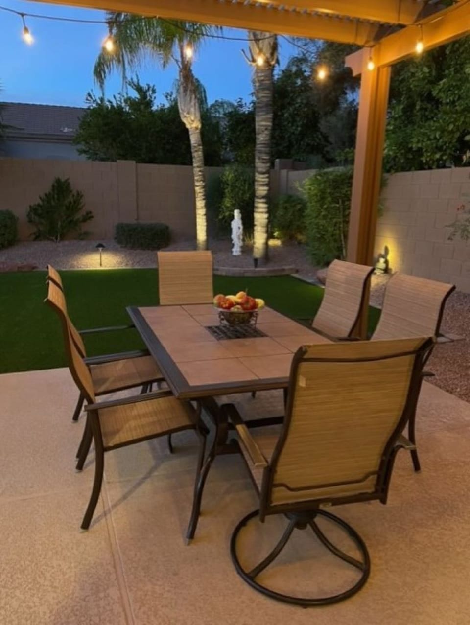 Relax as you dine outdoors under the pergola surrounds by twinkling lights