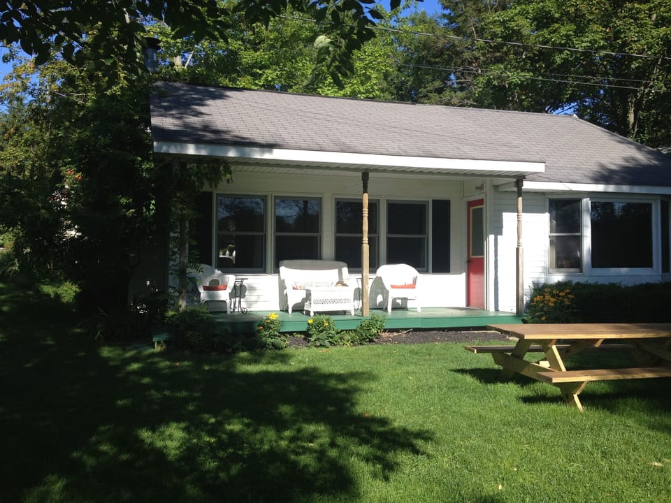 Beach facing side of the home with covered porch

