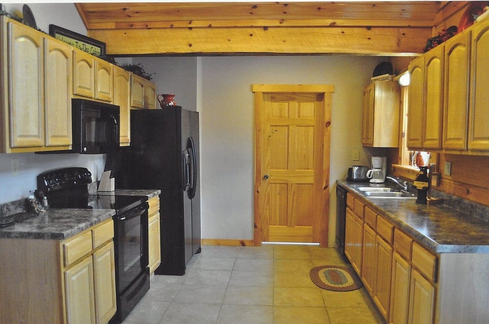 Kitchen area with laundry room through the door.