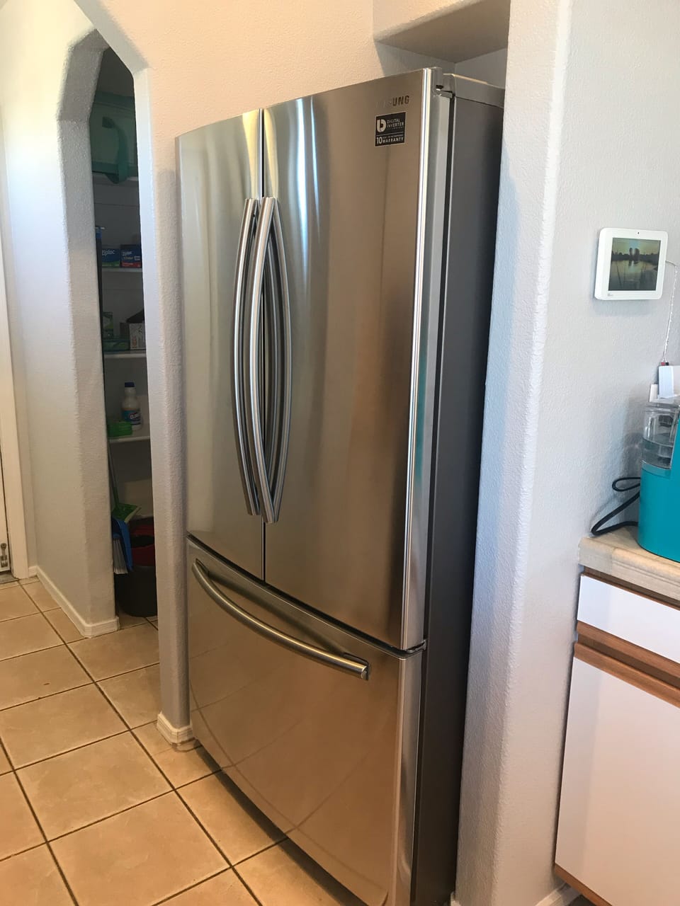 New French door refrigerator next to the large walk-in pantry