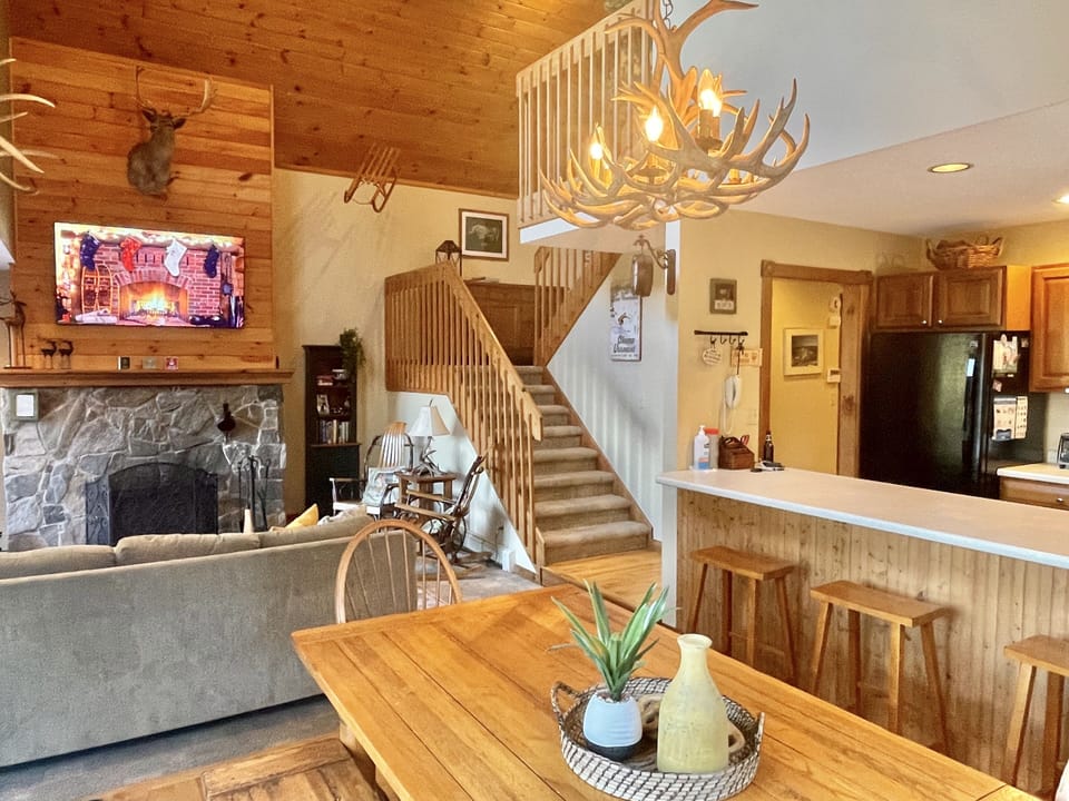Living Room with Wood Burning Fireplace and 65 inch flat screen HD TV. 
