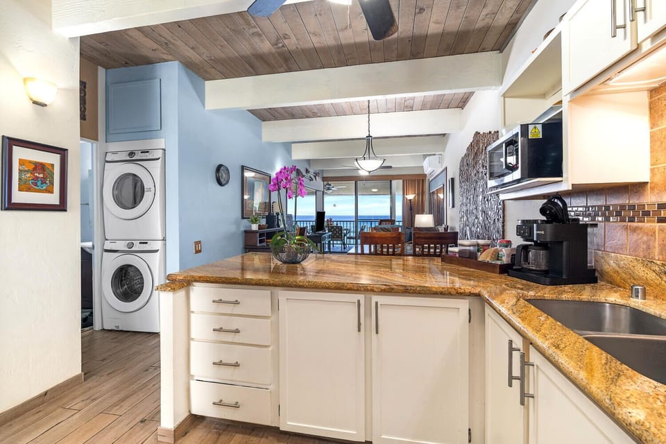 Well-equipped kitchen with utensils, pots, pans, dishes, glasses, knives, spices