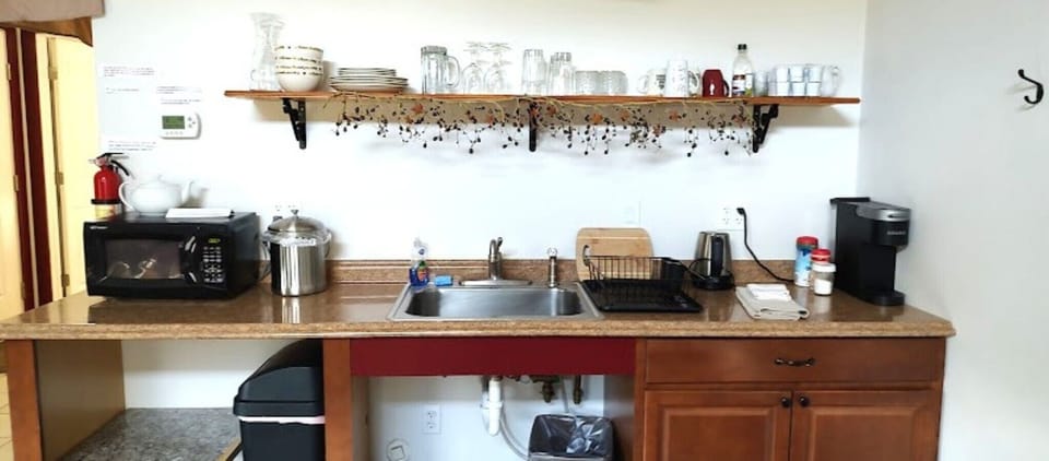 kitchenette with cups, plates and bowls