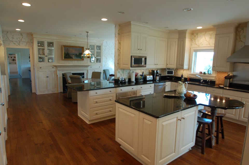 Kitchen looking into the additional dinning area. 2nd Fireplace behind table