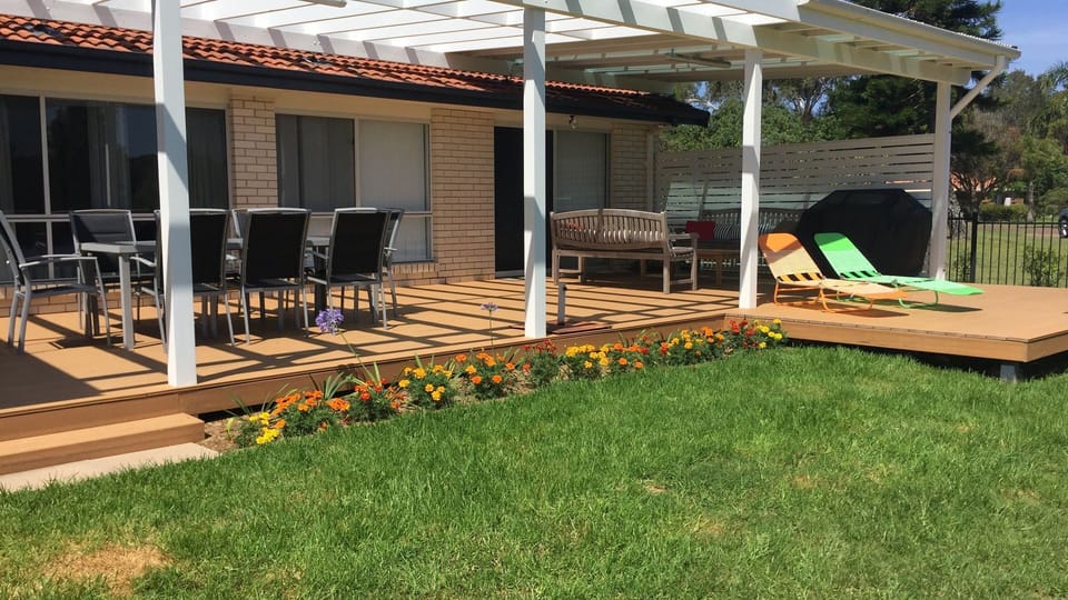 Large covered deck facing the lake. Outdoor dining and seating