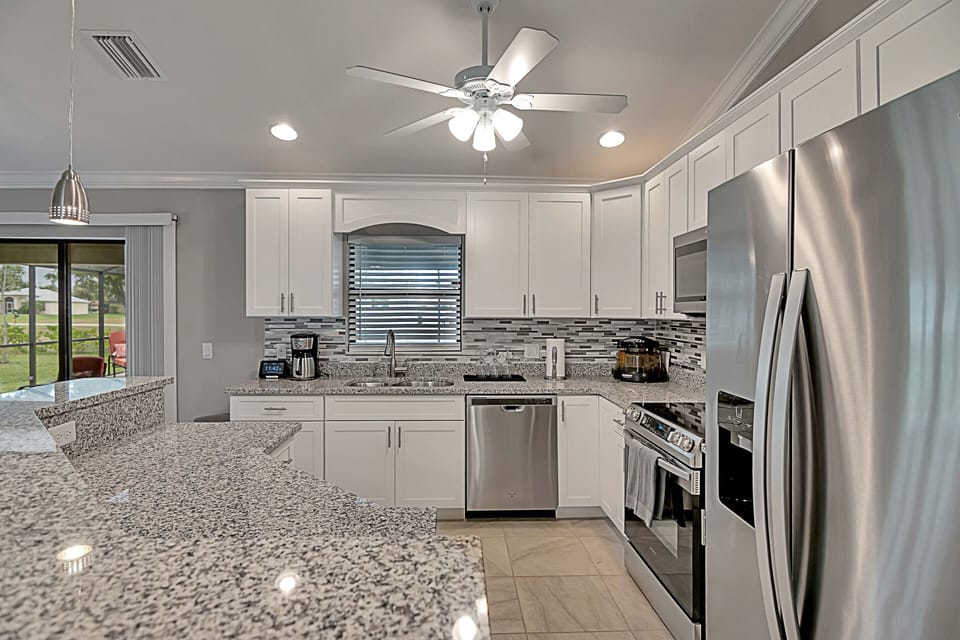 Modern kitchen that's fully stocked, coffee maker, cooking utensils and more!